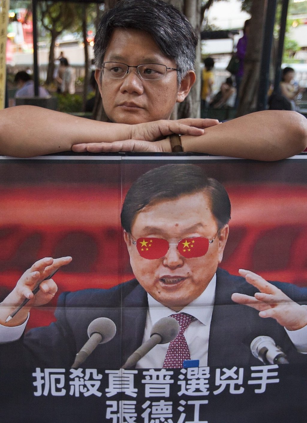 A protester with a picture of Zhang Dejiang during his visit to Hong Kong in May 2016. Photo: EPA