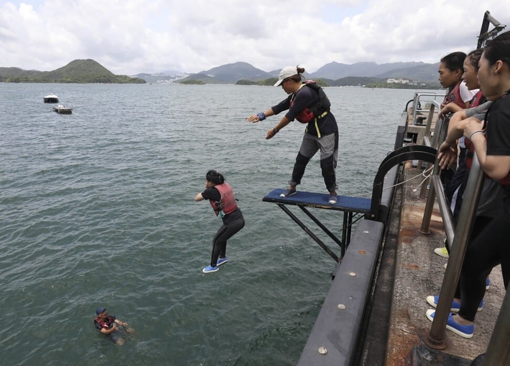 One by one, the girls edge forward, guided by their instructor. Photo: May Tse