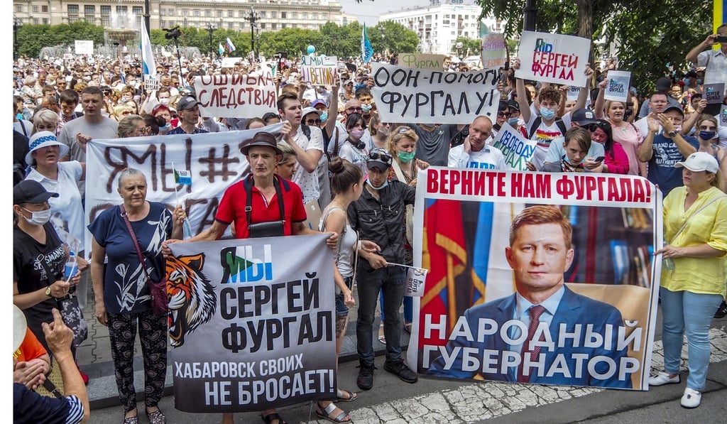 People hold posters reading “Freedom for Sergei Furgal, I am, we are Sergei Furgal”, “Give us Furgal back”, “Call Furgal home” during an unsanctioned protest in Khabarovsk, Russia. Photo: AP