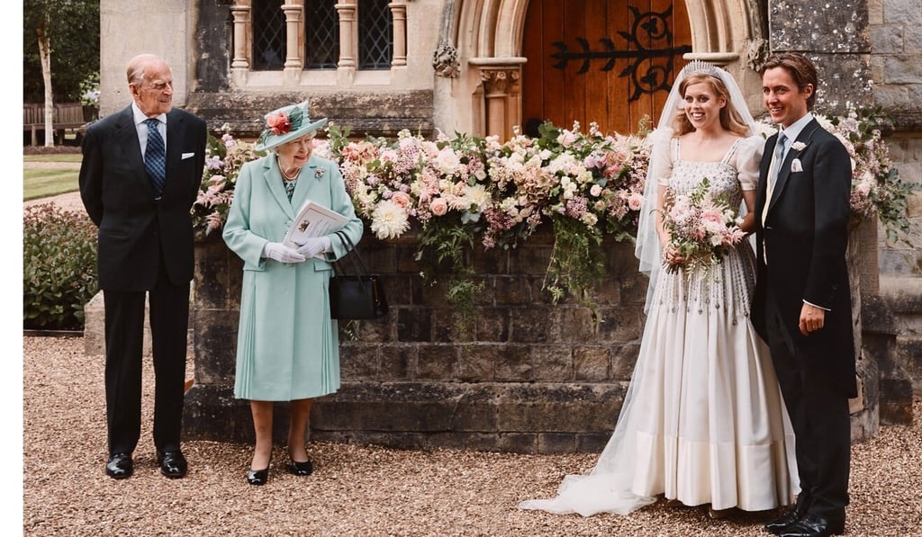 Britain's Queen Elizabeth and Prince Philip, the Duke of Edinburgh look on as their granddaughter Princess Beatrice and her new husband Edoardo Mapelli Mozzi pose after their wedding. Photo: EPA-EFE