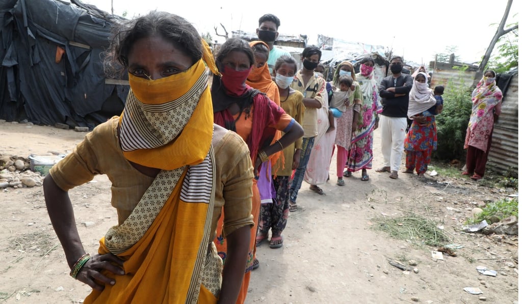 People wait for their Covid-19 tests at a slum area in Jammu, India. Photo: EPA-EFE