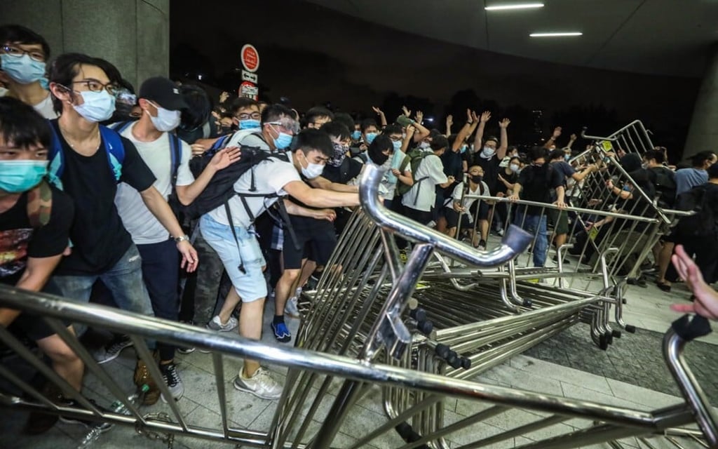 The assembly outside Legco turned disorderly as protesters moved mills barriers. Photo: Dickson Lee The assembly outside Legco turned disorderly as protesters moved mills barriers. Photo: Dickson Lee