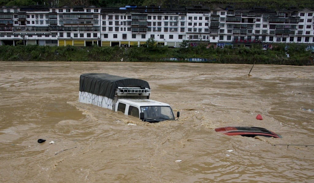 Vehicles are submerged in Congjiang county, Guizhou province in early June. Photo: Xinhua Vehicles are submerged in Congjiang county, Guizhou province in early June. Photo: Xinhua