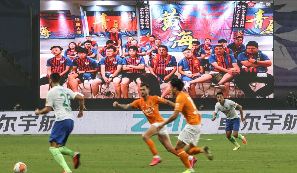 A giant screen shows fans of Qingdao Huanghai watching the live stream of the match. Photo: Xinhua