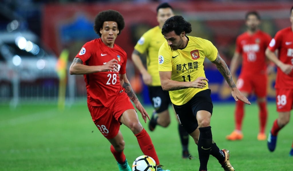 Guangzhou Evergrande's Ricardo Goulart (right) fights for the ball with Tianjin Quanjian's Axel Witsel during the 2018 AFC Champions League. Photo: AFP