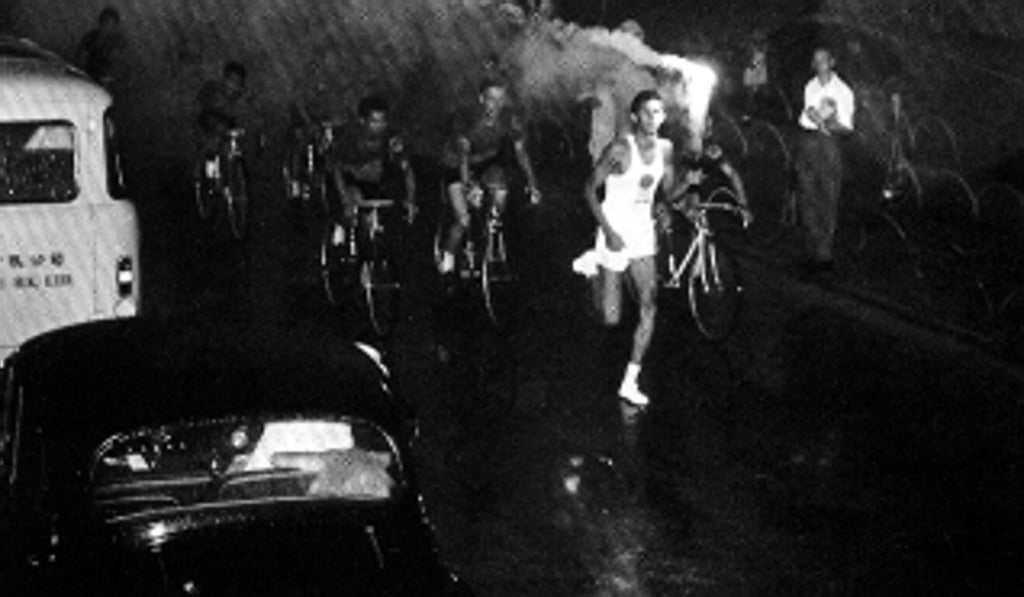 William Hill is seen running along Nathan Road as one of the torch-bearers for the 1964 Tokyo Olympic Games when the Olympic flame arrived in Hong Kong. Photo: Handout William Hill is seen running along Nathan Road as one of the torch-bearers for the 1964 Tokyo Olympic Games when the Olympic flame arrived in Hong Kong. Photo: Handout