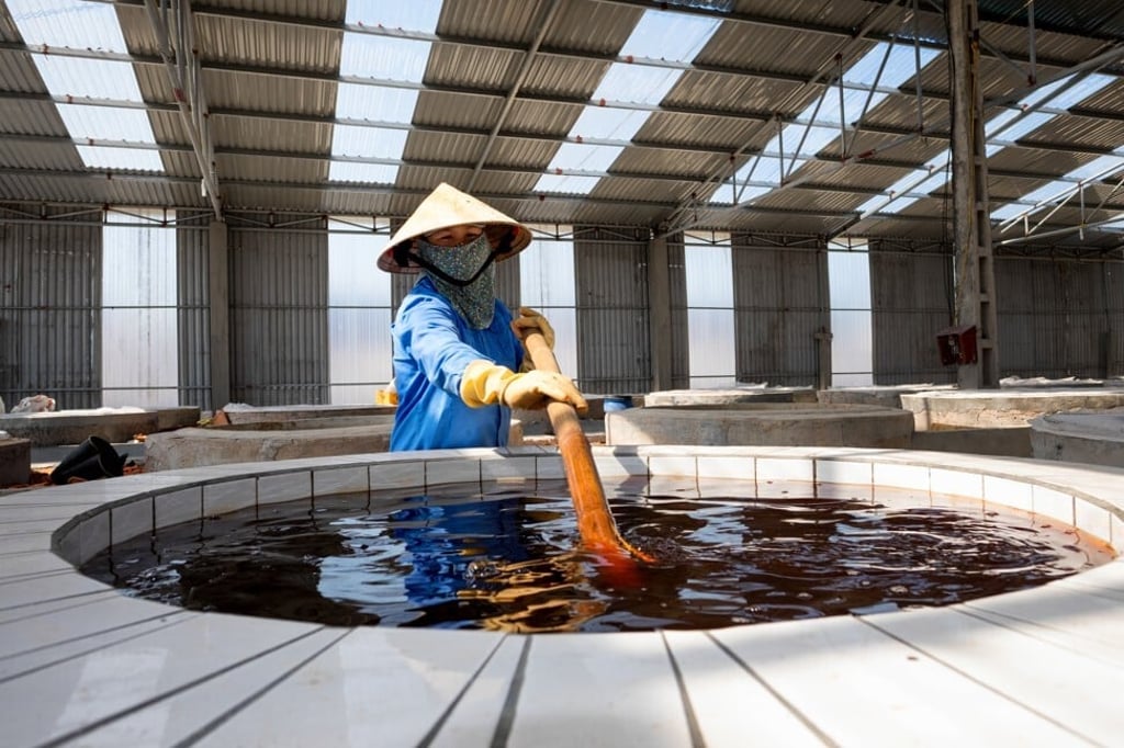 A worker stirs traditional fish sauce at a factory in Nghe An, Vietnam. Photo: Shutterstock