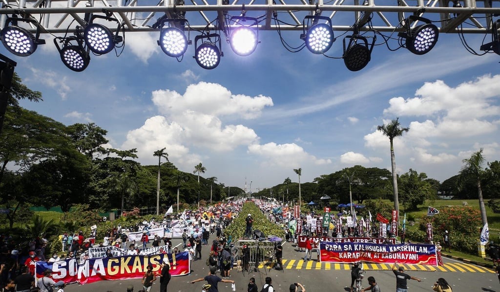 Protesters march along an avenue of the University of the Philippines ahead of President Duterte’s State of the Nation Address. Photo: EPA-EFE