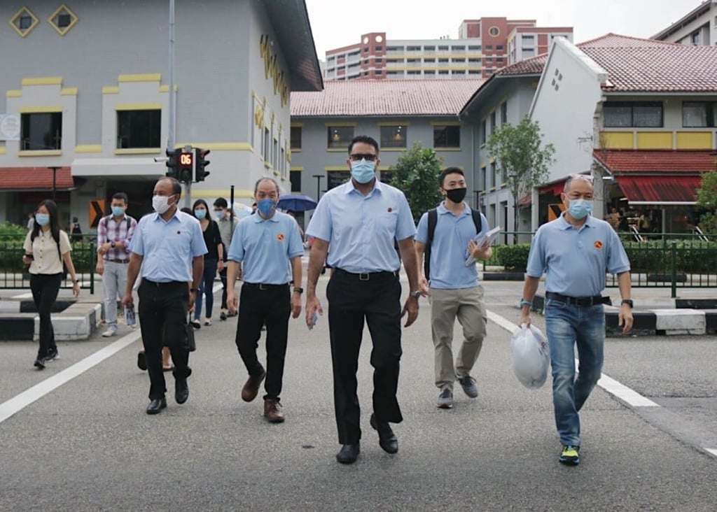 Pritam Singh (centre) with former Workers’ Party chief Low Thia Khiang (fourth from right) and party members at their Aljunied stronghold in the lead-up to the July 10 election. Photo: Dewey Sim