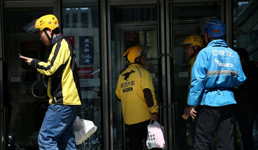 Drivers of food delivery service Ele.me (in blue) and Meituan (in yellow) seen in Beijing on April 11, 2018. Photo: Reuters