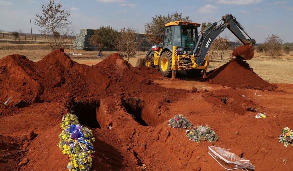 An excavator digs graves in South Africa, where the death toll from Covid-19 has passed 7,800. Photo: Reuters An excavator digs graves in South Africa, where the death toll from Covid-19 has passed 7,800. Photo: Reuters