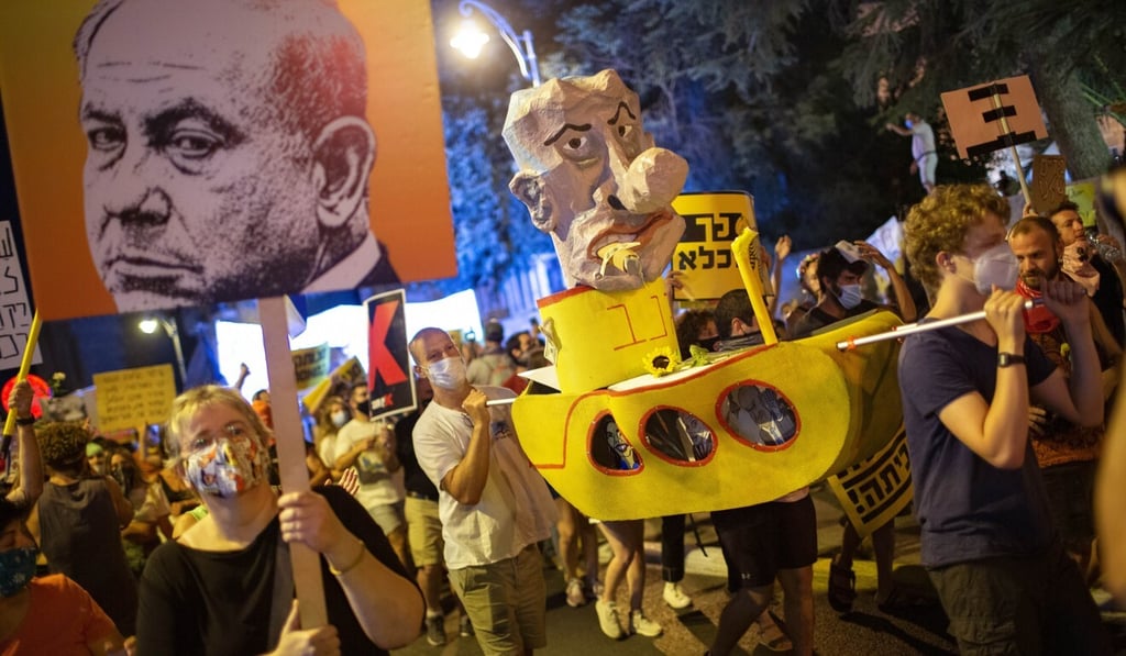 Demonstrators chant slogans and hold signs during a rally against Israel's Prime Minister Benjamin Netanyahu outside his residence in Jerusalem. Photo: AP Photo