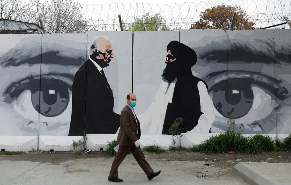 An Afghan man walks past a mural showing Zalmay Khalilzad, the US envoy for peace in Afghanistan, and Mullah Abdul Ghani Baradar, the leader of the Taliban delegation, in Kabul. Photo: Reuters An Afghan man walks past a mural showing Zalmay Khalilzad, the US envoy for peace in Afghanistan, and Mullah Abdul Ghani Baradar, the leader of the Taliban delegation, in Kabul. Photo: Reuters