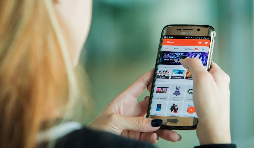 An employee shows off the Shopee app at the company’s Singapore headquarters in this 2016 photo. Photo: Bloomberg