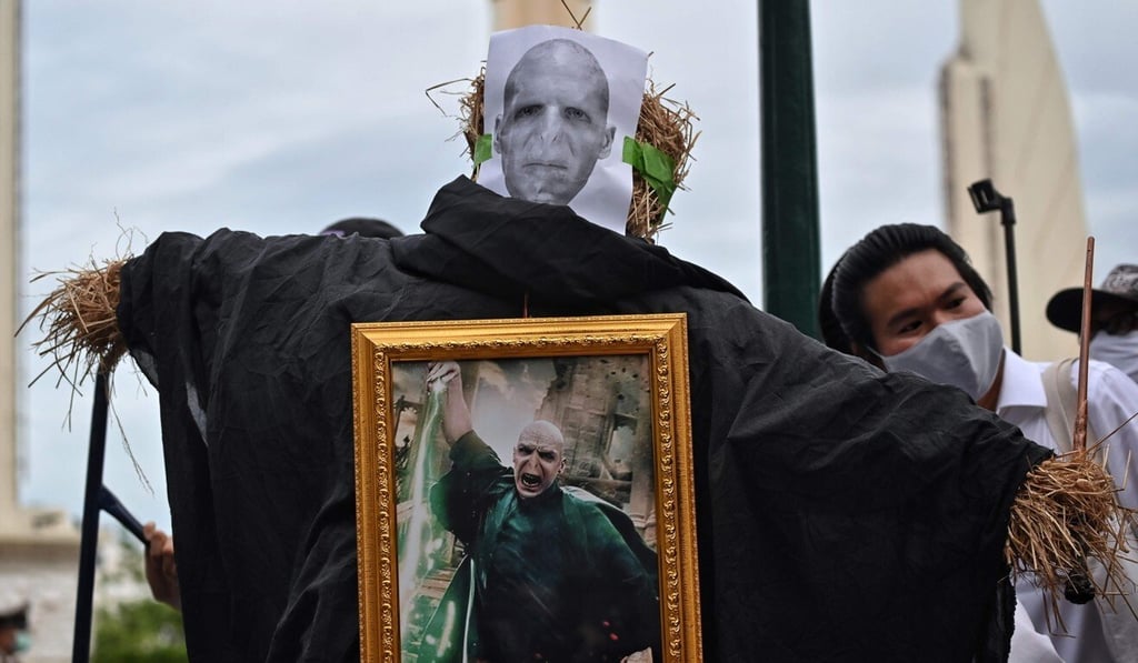 A protester poses next to an effigy of Voldemort, the villain of the Harry Potter books, during an anti-government rally in Bangkok on Monday. Photo: AFP