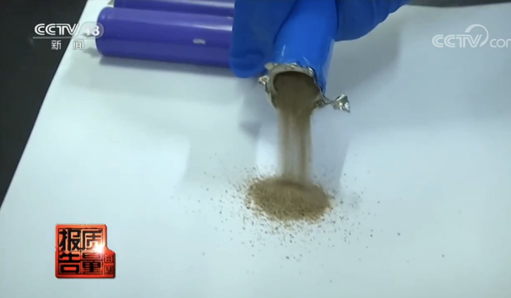 Investigators found one of the power banks purchased by CCTV has a battery cell filled with sand. Image: CCTV Investigators found one of the power banks purchased by CCTV has a battery cell filled with sand. Image: CCTV