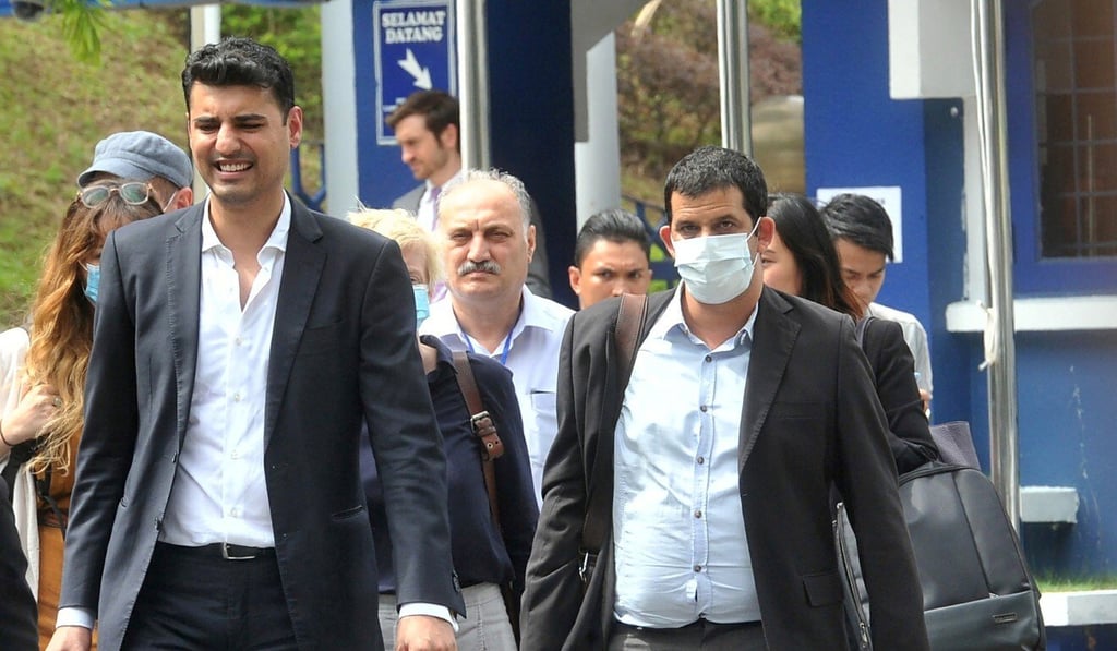 Australian Al Jazeera journalist, reporter/senior producer Drew Ambrose, right, leaves the Bukit Aman police headquarters after being questioned by the Malaysian police over a documentary about the country's arrests of undocumented migrants. Photo: AP Photo