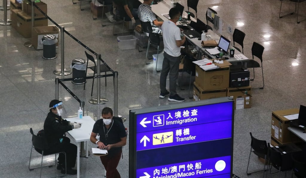 Inbound travellers receive their quarantine wristbands upon arrival at the Hong Kong International Airport in July. Photo: Nora Tam Inbound travellers receive their quarantine wristbands upon arrival at the Hong Kong International Airport in July. Photo: Nora Tam