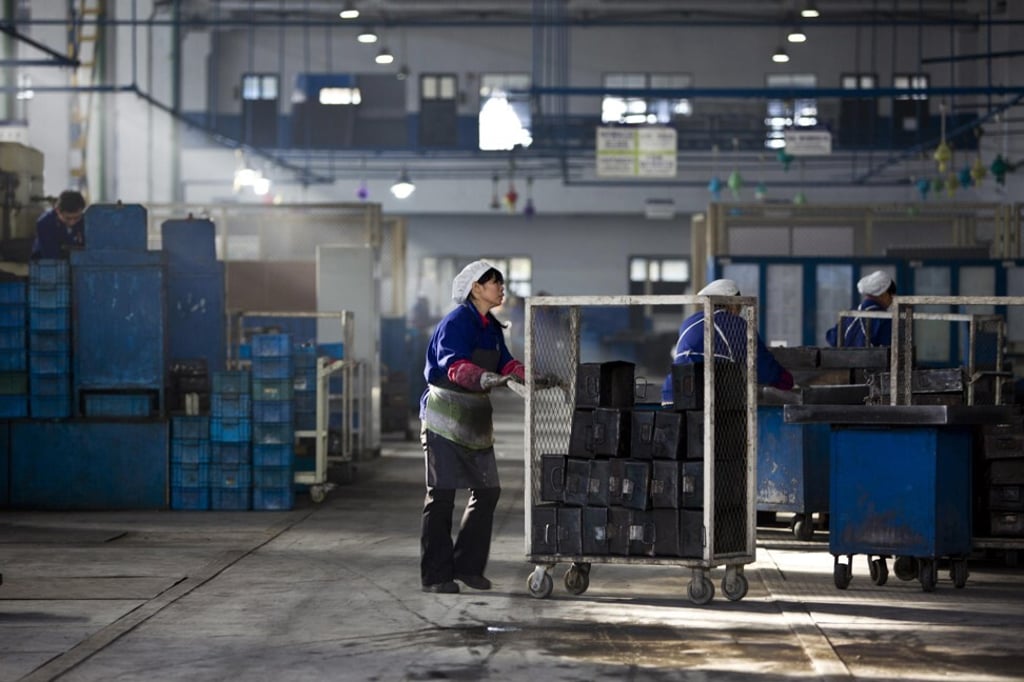 An employee works at a production line at a Wanxiang electric vehicle factory in Hangzhou, Zhejiang province in January 2014. Photo: Reuters