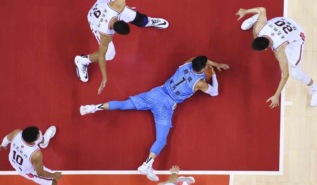 Lin on the floor surrounded by Tigers players.