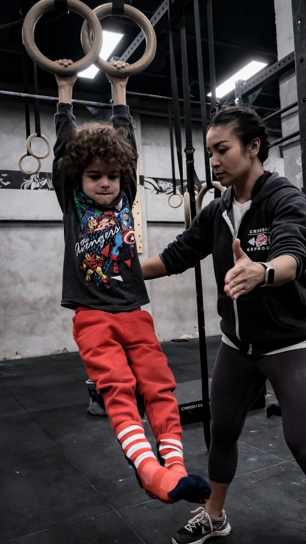Michelle O’Brien helps a child on the rings. Photo: Handout