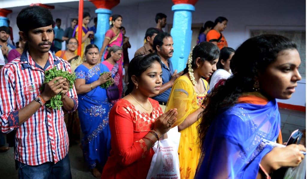 Student visa hopefuls offer prayers to Lord Balaji, known as the 'Visa God', at the Chilkur Balaji Temple in Hyderabad. Photo: AFP