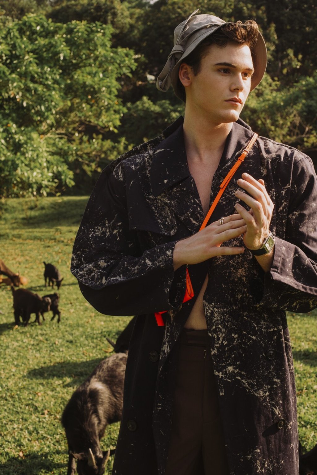 Maison Margiela trench coat, HK$21,200 (US$2,735); pants, price upon request; Valentino neck wallet, HK$3,900; Louis Vuitton hat, HK$5,700; Cartier watch, HK$44,100; ring, HK$18,300.