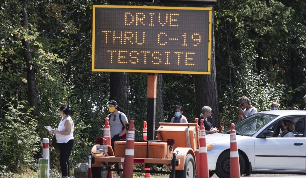People wait in line at a Covid-19 testing facility in Burnaby, British Columbia, on Thursday. Photo: Canadian Press via AP People wait in line at a Covid-19 testing facility in Burnaby, British Columbia, on Thursday. Photo: Canadian Press via AP