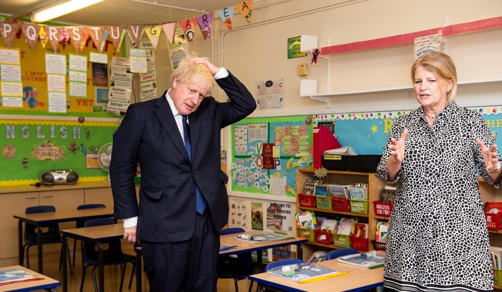 Britain's Prime Minister Boris Johnson gestures as he visits St Joseph’s Catholic School in Upminster, London. Photo: Pool via Reuters