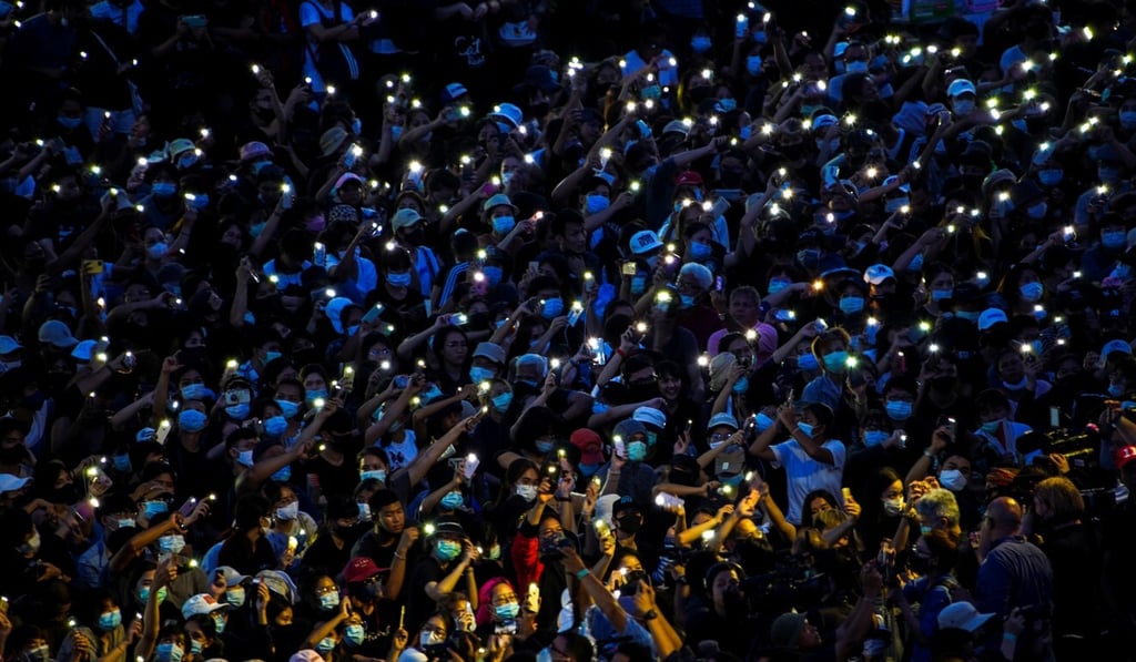Protesters use mobile phones as flashlights as they attend Sunday’s rally in Bangkok. Photo: Reuters