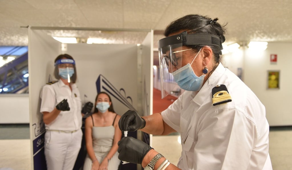An MSC Grandiosa crew member undergoes a swab test for Covid-19 before boarding. Photo: EPA-EFE/MSC Cruises