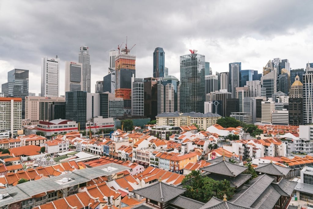 Skyscrapers stand beyond traditional shophouses in the central business district in Singapore, on Friday, March 27, 2020. Singapore delivered a second stimulus package of S$48 billion ($33 billion) to fight the coronavirus outbreak, drawing on national reserves for the first time since the global financial crisis to support an economy heading for recession. Photo: Bloomberg