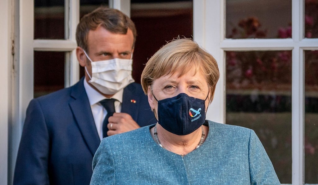 German Chancellor Angela Merkel and French President Emmanuel Macron arrive for a press conference in face masks after their meeting at Fort de Bregancon on Thursday. Photo: dpa