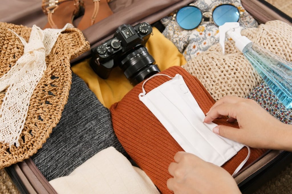 Don’t forget your mask and hand sanitiser when travelling. Photo: Getty Images Don’t forget your mask and hand sanitiser when travelling. Photo: Getty Images