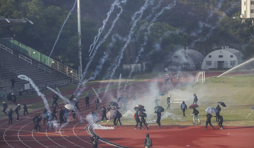 Police fire tear gas rounds at protesters on the Sir Philip Haddon-Cave Sports Field on the campus of Chinese University last November. Photo: Winson Wong Police fire tear gas rounds at protesters on the Sir Philip Haddon-Cave Sports Field on the campus of Chinese University last November. Photo: Winson Wong