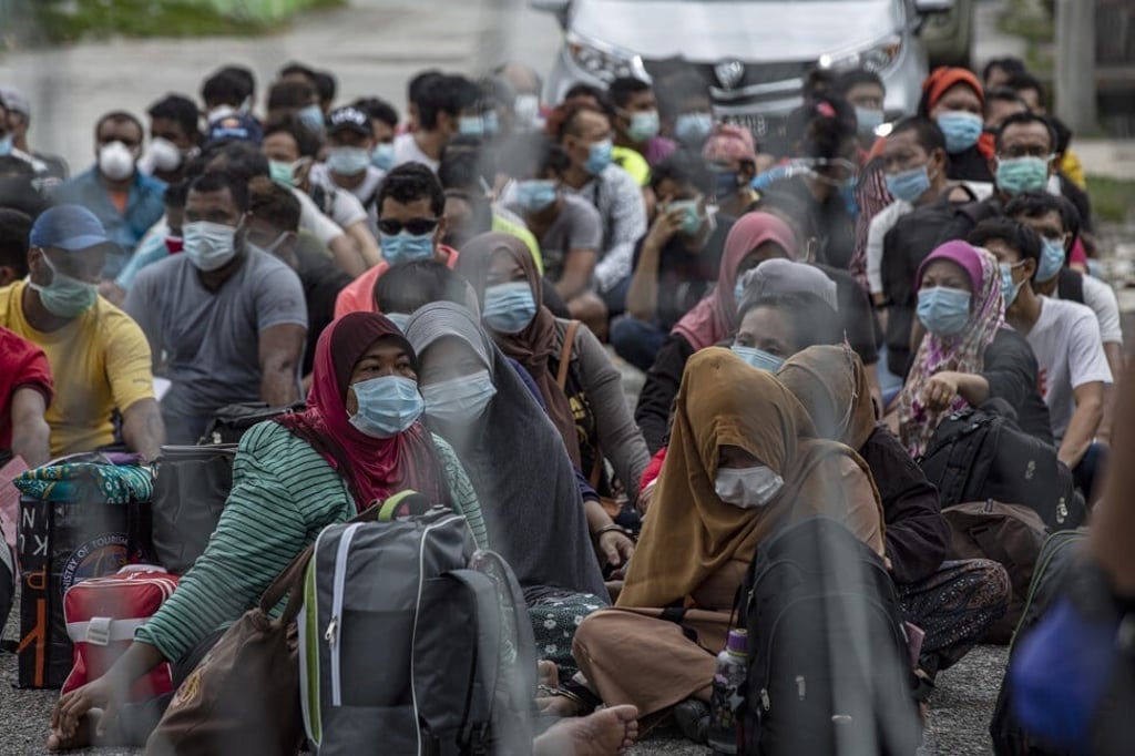 Undocumented migrants sit during a raid in Petaling Jaya near Kuala Lumpur on August 20, 2020. Photo: EPA-EFE Undocumented migrants sit during a raid in Petaling Jaya near Kuala Lumpur on August 20, 2020. Photo: EPA-EFE