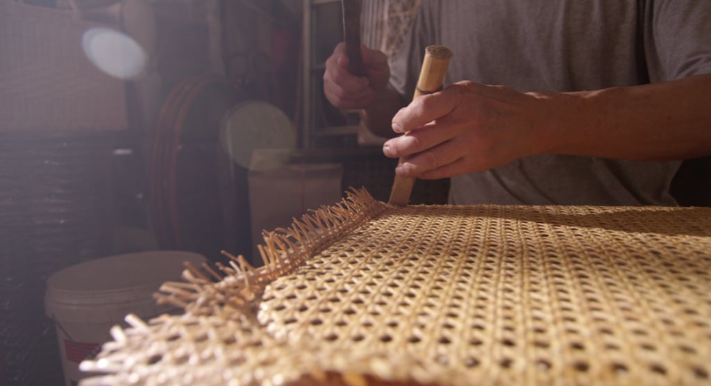 Hammers and chisels are used to carry out the laborious process of rattan weaving, which forms the hard and durable seats of chairs.