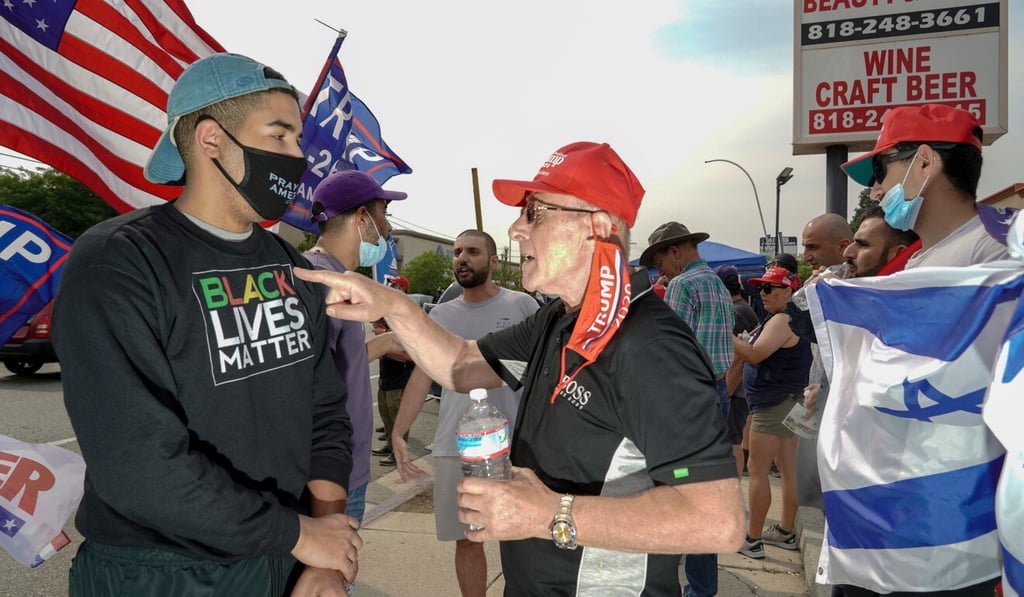 Trump supporters holding a rally confront a counter-protester wearing a “Black Lives Matter” shirt in Tujunga, California, on Friday. Photo: AFP