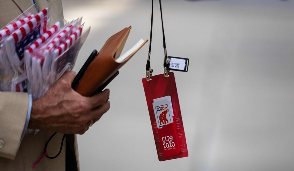 A bluetooth tracking device can be seen hanging off a convention delegate's official credential before he enters the Charlotte Convention Centre in Charlotte, North Carolina, on Sunday. Photo: AFP A bluetooth tracking device can be seen hanging off a convention delegate's official credential before he enters the Charlotte Convention Centre in Charlotte, North Carolina, on Sunday. Photo: AFP