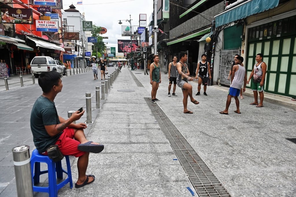 Vendors and bar staff from Myanmar play chinlone as they wait for customers at Khao San Road in Bangkok. The popular tourist district has been empty due to travel restrictions on travellers entering Thailand during the coronavirus. Photo: AFP