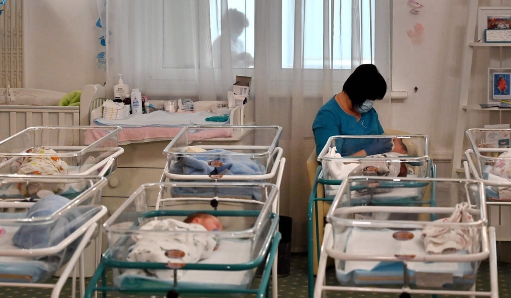 A nurse cares for newborn babies at Kiev’s Venice hotel. In May, Ukrainian authorities also reported around 100 babies born to surrogate mothers were stranded because of the border closures. Photo: AFP A nurse cares for newborn babies at Kiev’s Venice hotel. In May, Ukrainian authorities also reported around 100 babies born to surrogate mothers were stranded because of the border closures. Photo: AFP