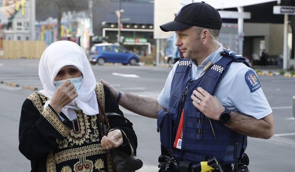 A policeman gestures to a woman as she prepares to enter the Christchurch High Court for the final day in the sentencing hearing for Brenton Tarrant on Thursday. Photo: AP