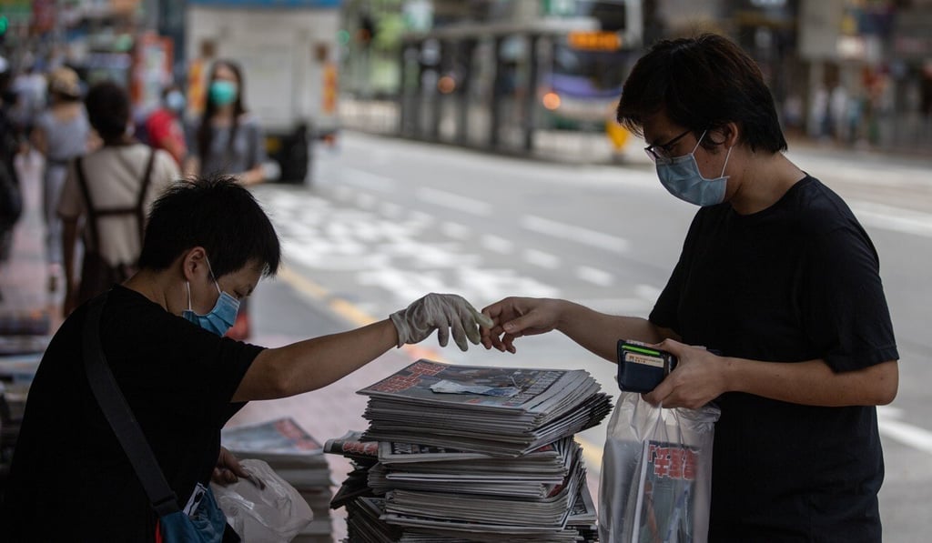 A man buys a copy of Apple Daily the day after founder Jimmy Lai was arrested under the new national security law. Photo: EPA-EFE A man buys a copy of Apple Daily the day after founder Jimmy Lai was arrested under the new national security law. Photo: EPA-EFE