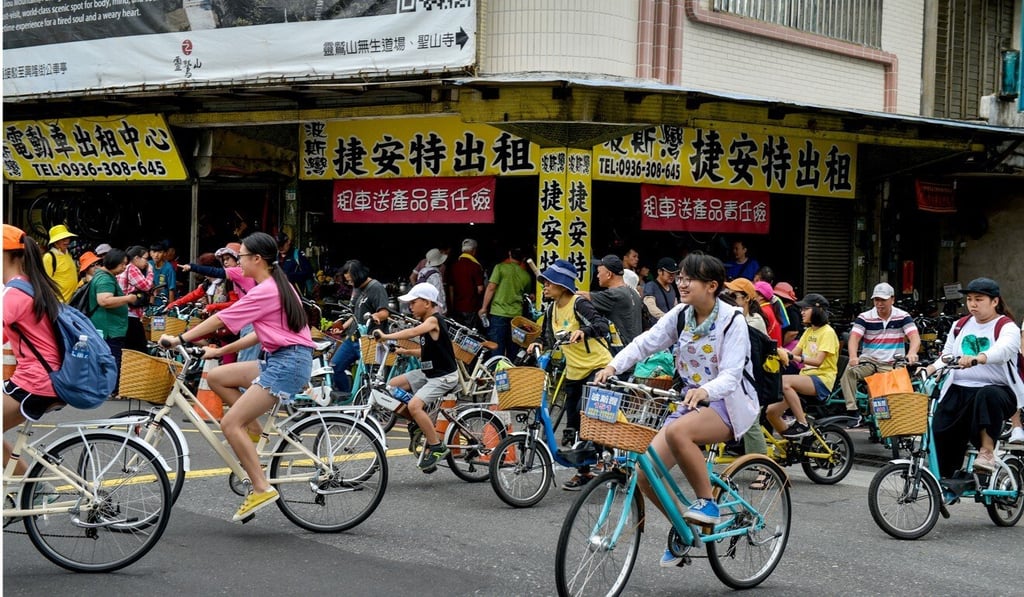 Daytrippers off the train from Taipei hire bikes from rental shops near the Caoling railway tunnel. Photo: Chris Stowers /Panos