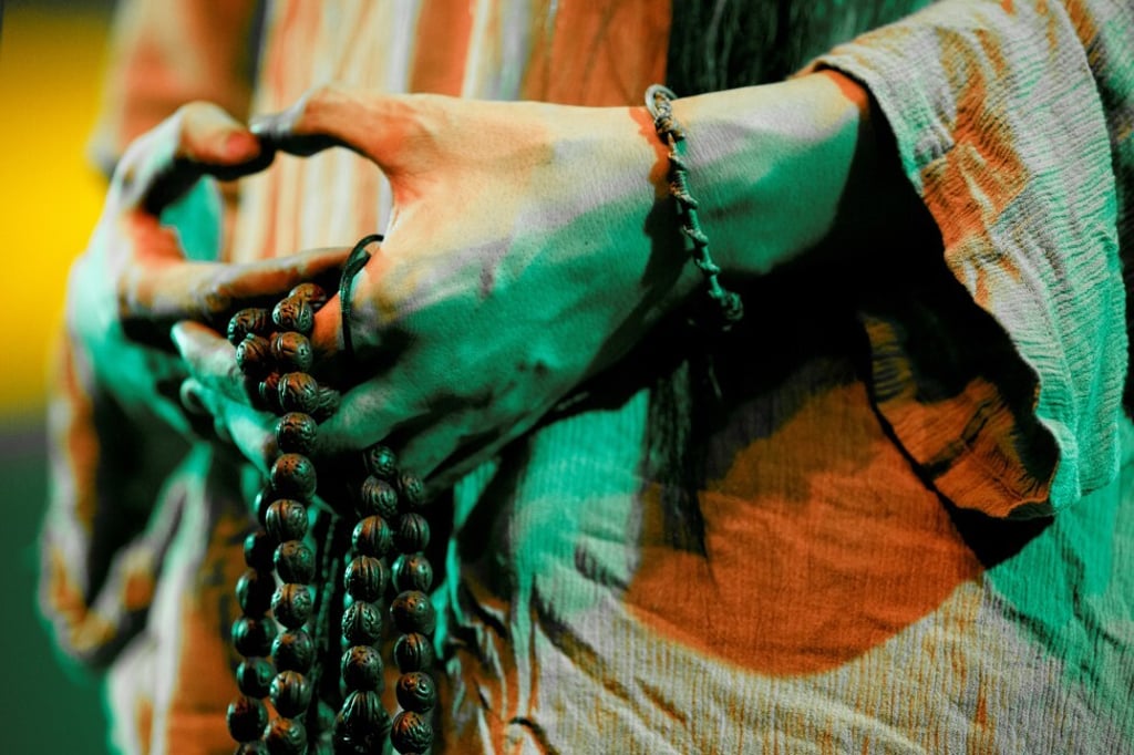Shui Shu holds prayer beads as he performs. Photo: Reuters/Thomas Peter Shui Shu holds prayer beads as he performs. Photo: Reuters/Thomas Peter