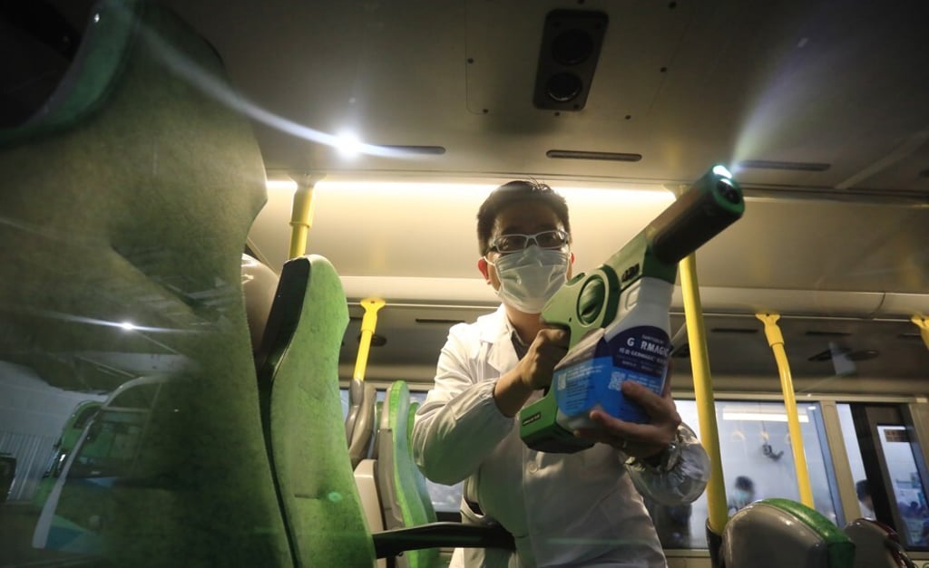 The Germagic Thyme antimicrobial coating, invented by Hong Kong University of Science and Technology scientists, is sprayed inside a Hong Kong bus. Photo: May Tse