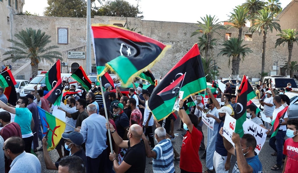Demonstrators march during an anti-government protest in Tripoli, Libya. Photo: Reuters