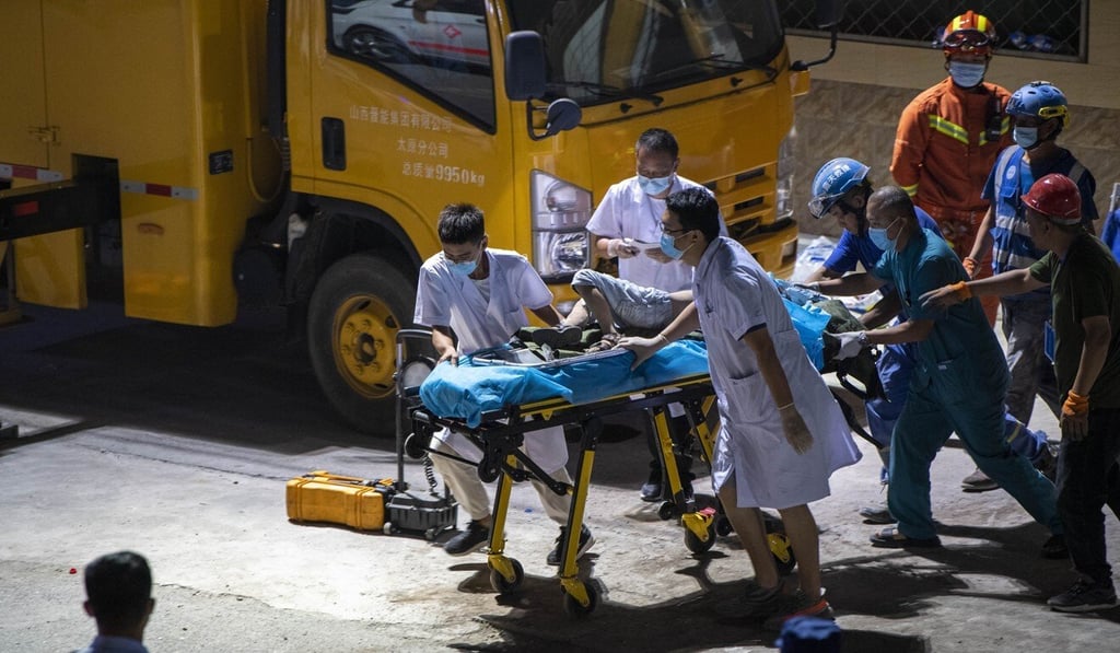A boy is rescued from the site of the collapsed restaurant in Xiangfen county on Saturday. Photo: Xinhua