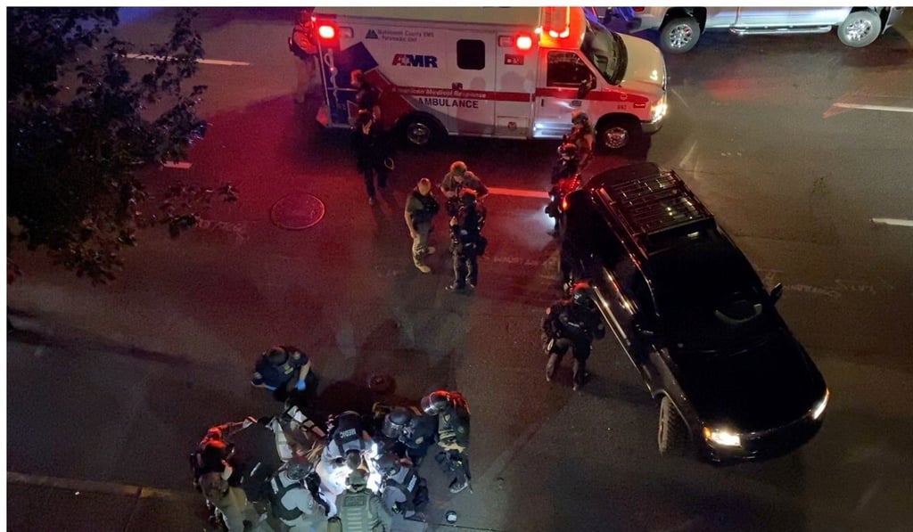 Paramedics and police surround the victim of a shooting in Portland, Oregon. Photo: Reuters