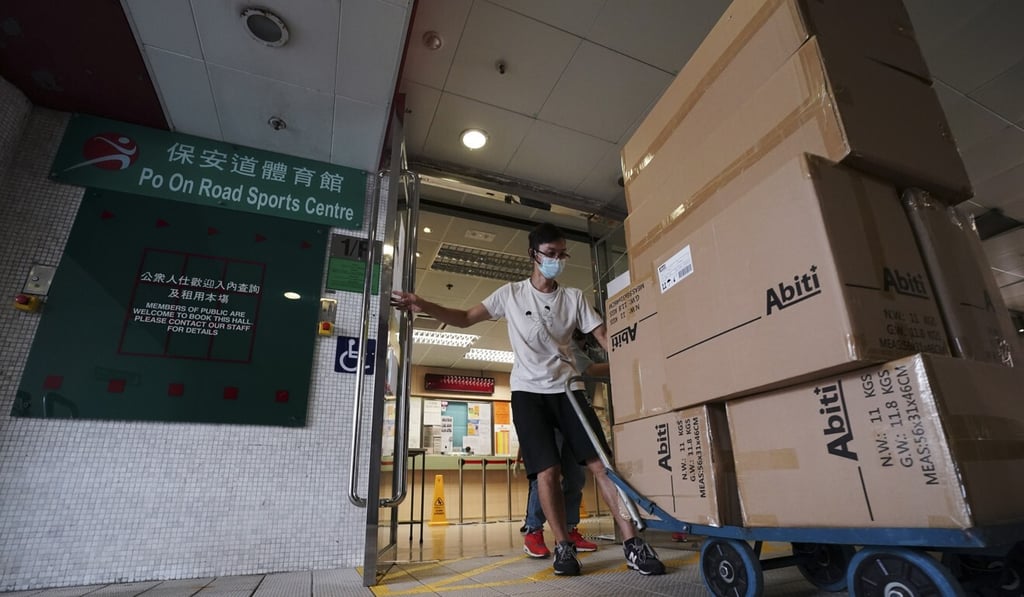 A worker delivers supplies on Sunday to the Po On Road Sports Centre in Cheung Sha Wan, where a makeshift Covid-19 community screening centre is being set up. Photo: Felix Wong